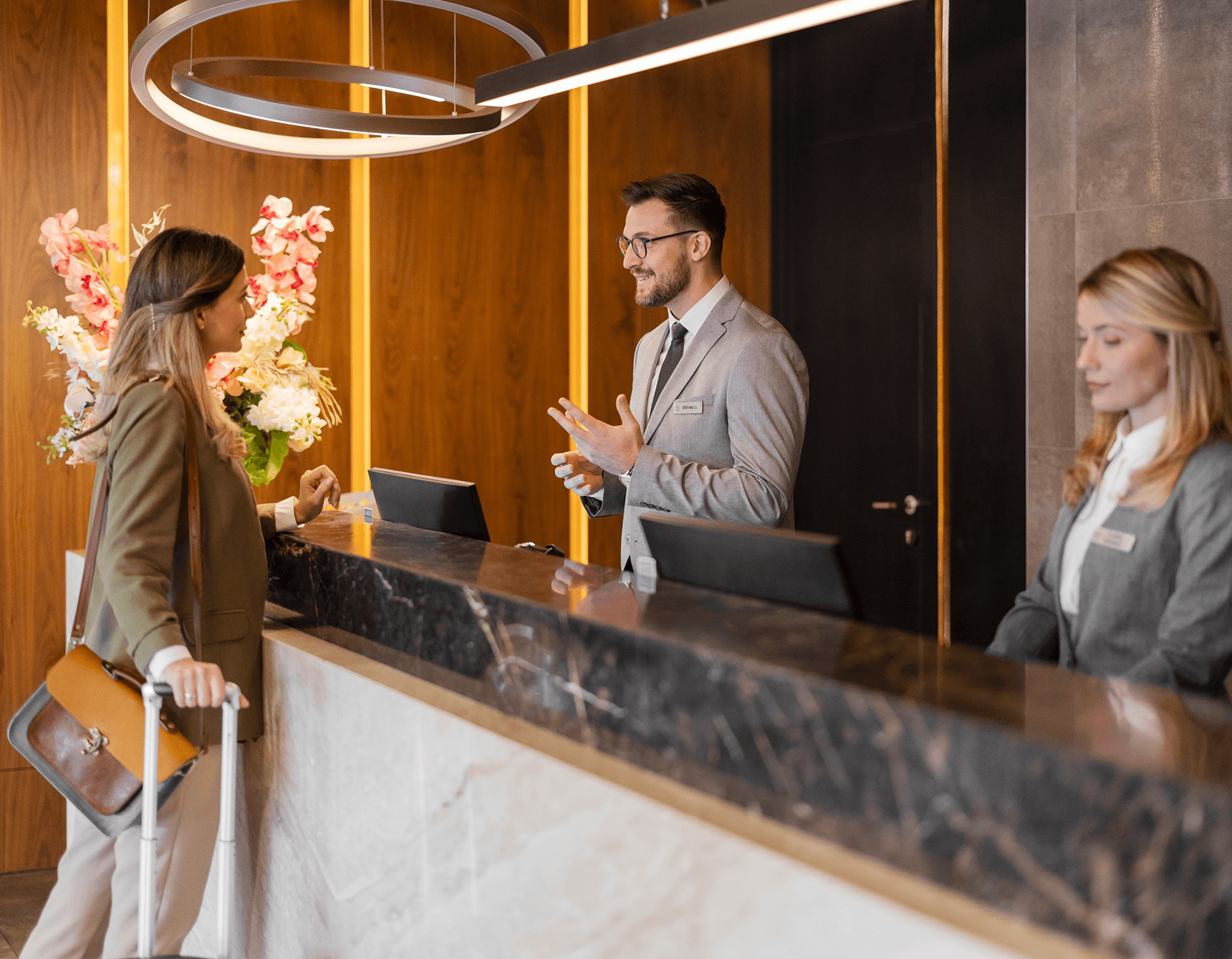 Woman checking in at hotel lobby